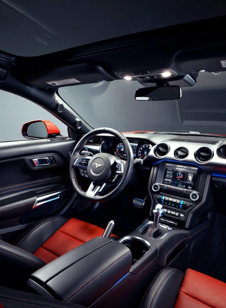 Interior view of the Ford Mustang GT Fastback showing its digital cluster, bucket seats, and sporty cockpit design.