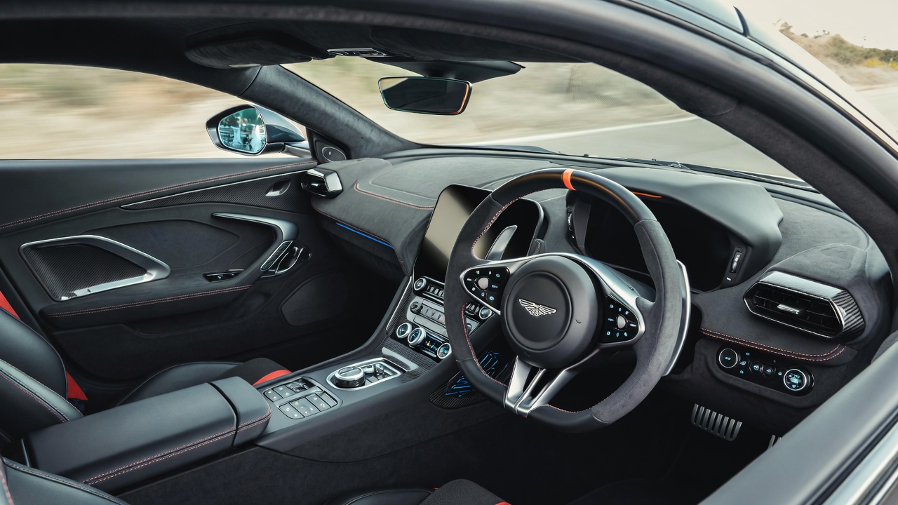 Driver-focused interior of Aston Martin Vantage V8 with luxury materials.