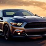 Modern Ford Mustang GT Fastback driving on a highway during sunset with its iconic fastback silhouette.