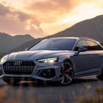 Audi RS5 Avant performance wagon parked on a scenic mountain road at sunrise.