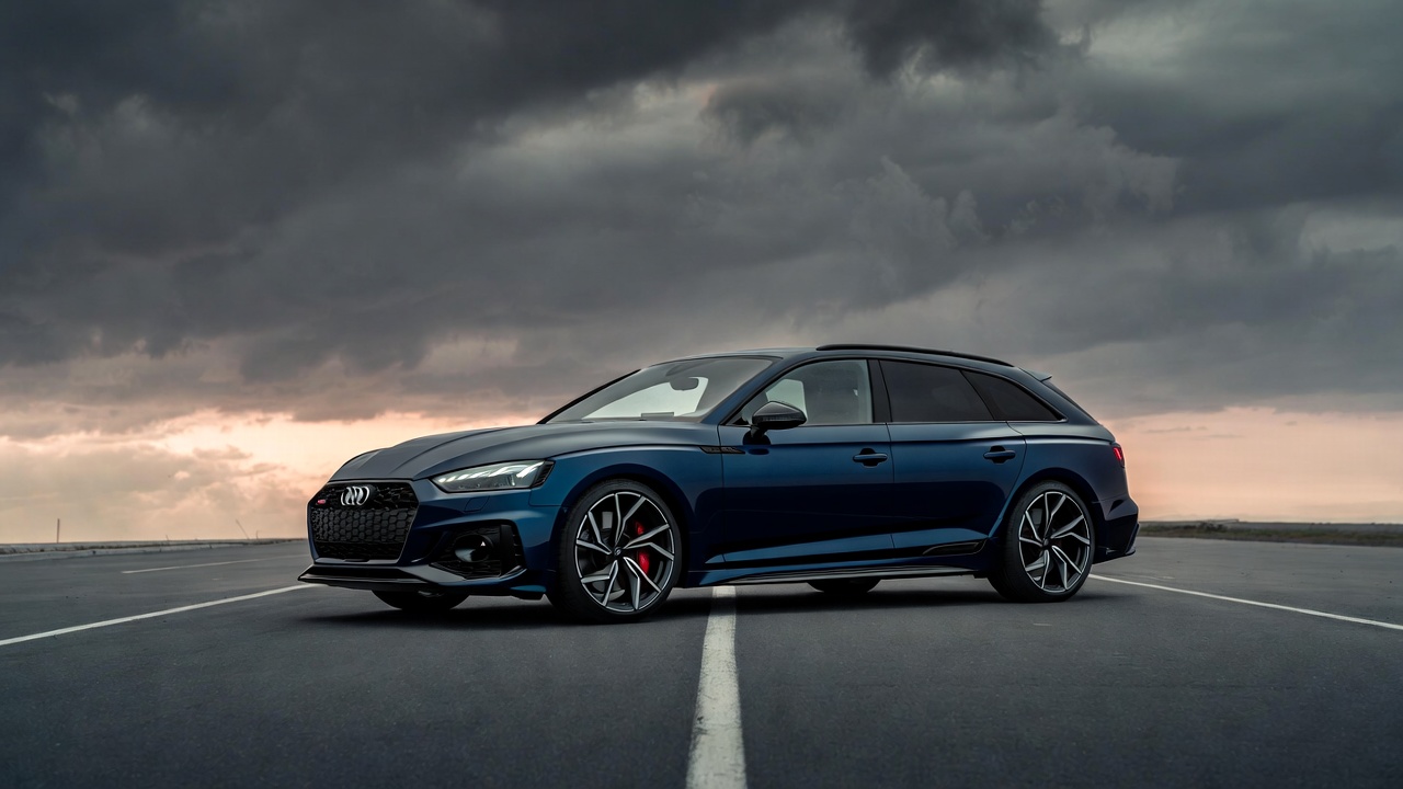Audi RS5 Avant parked on open road symbolizing balance of power and practicality.
