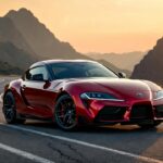 Toyota GR Supra parked on a mountain road at sunrise showing aggressive design and sporty stance.