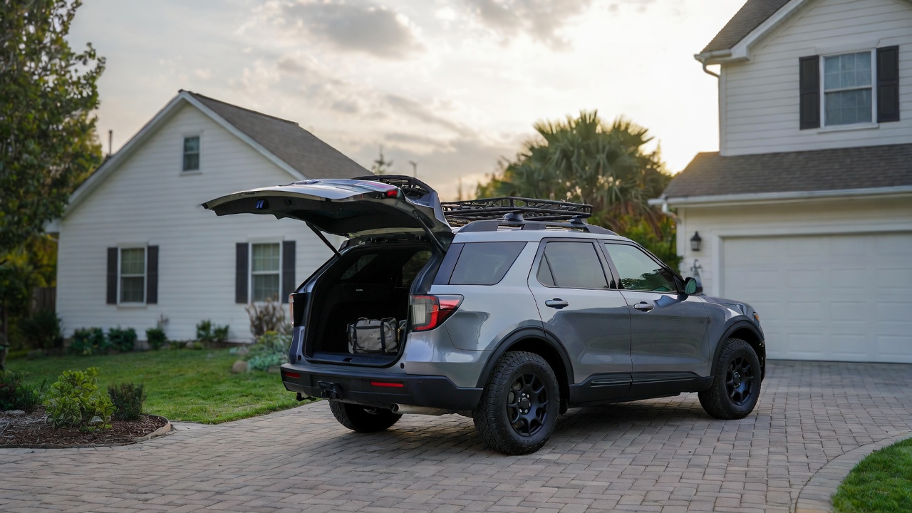 Family loading camping gear into Ford Explorer Tremor showing practicality and ownership value.