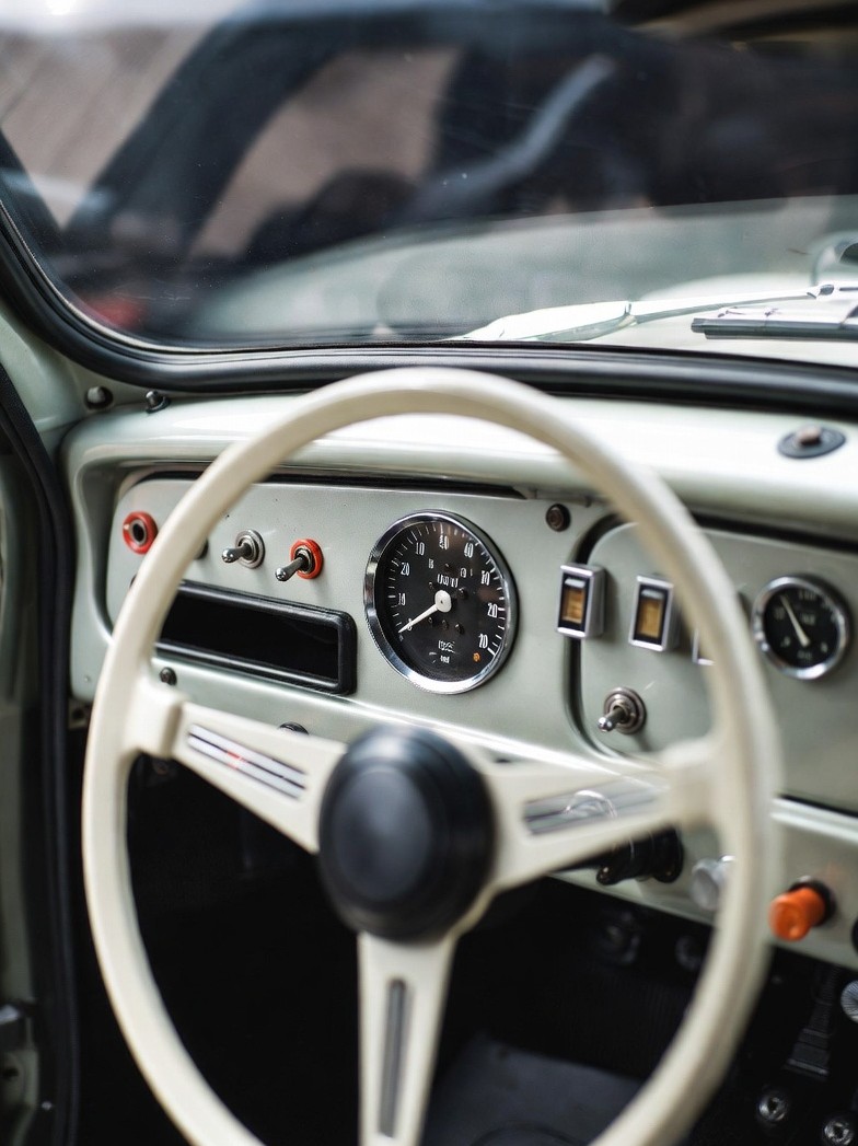 Mini Cooper Mk1 exterior design with round headlights and compact grille.