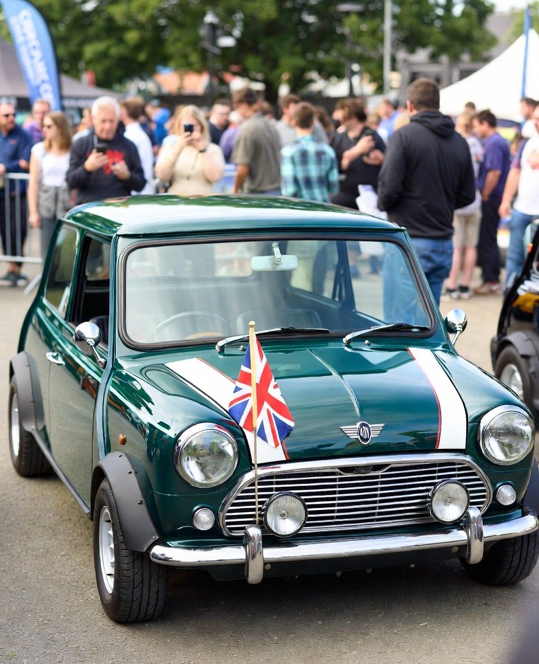 Restored Mini Cooper Mk1 displayed at a classic car show.