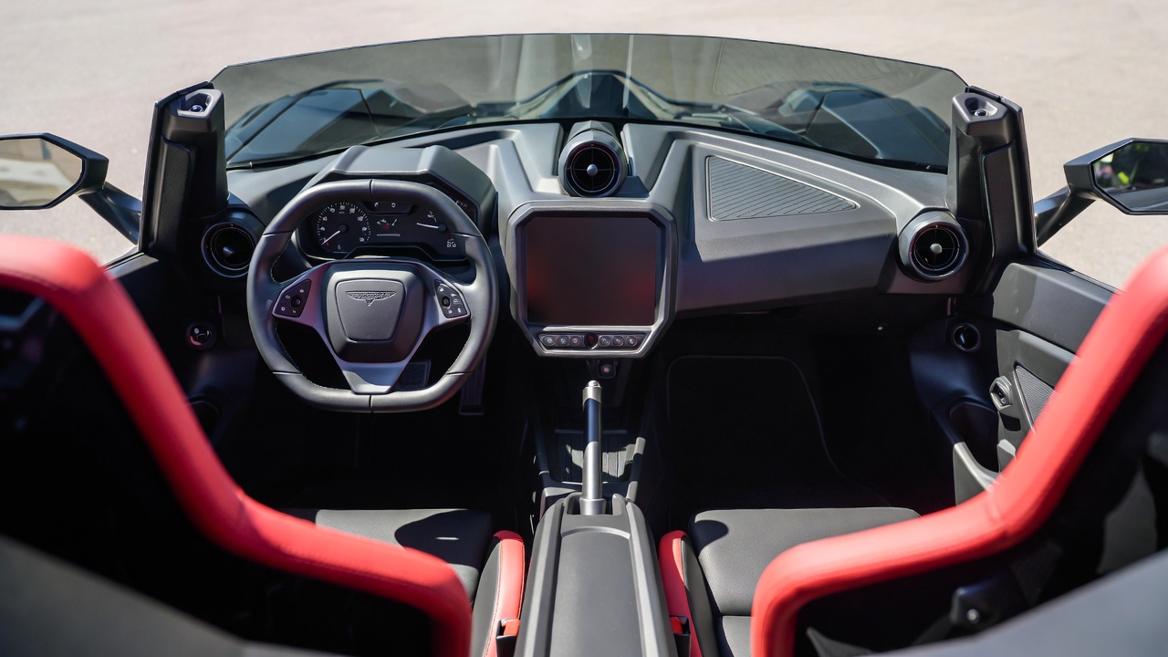 Polaris Slingshot interior cockpit with sporty steering wheel and digital display