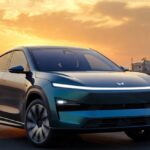 Mahindra XEV 9S futuristic electric SUV parked in Indian city at sunset.