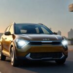 Kia Syros compact SUV parked in a modern Indian city at sunset with LED headlamps glowing.