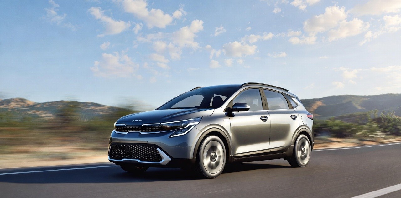 Kia Syros driving on highway showing stability and performance.